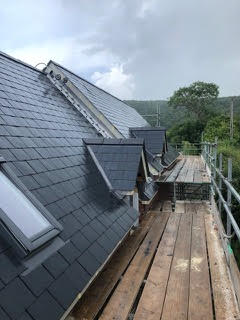 Slate roofing with scaffolding on a Dorset property